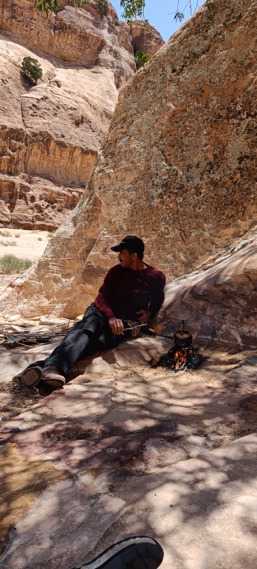 Mohammad Fdoul sitting by the campfire during a Desert Wolf Horse Riding tour